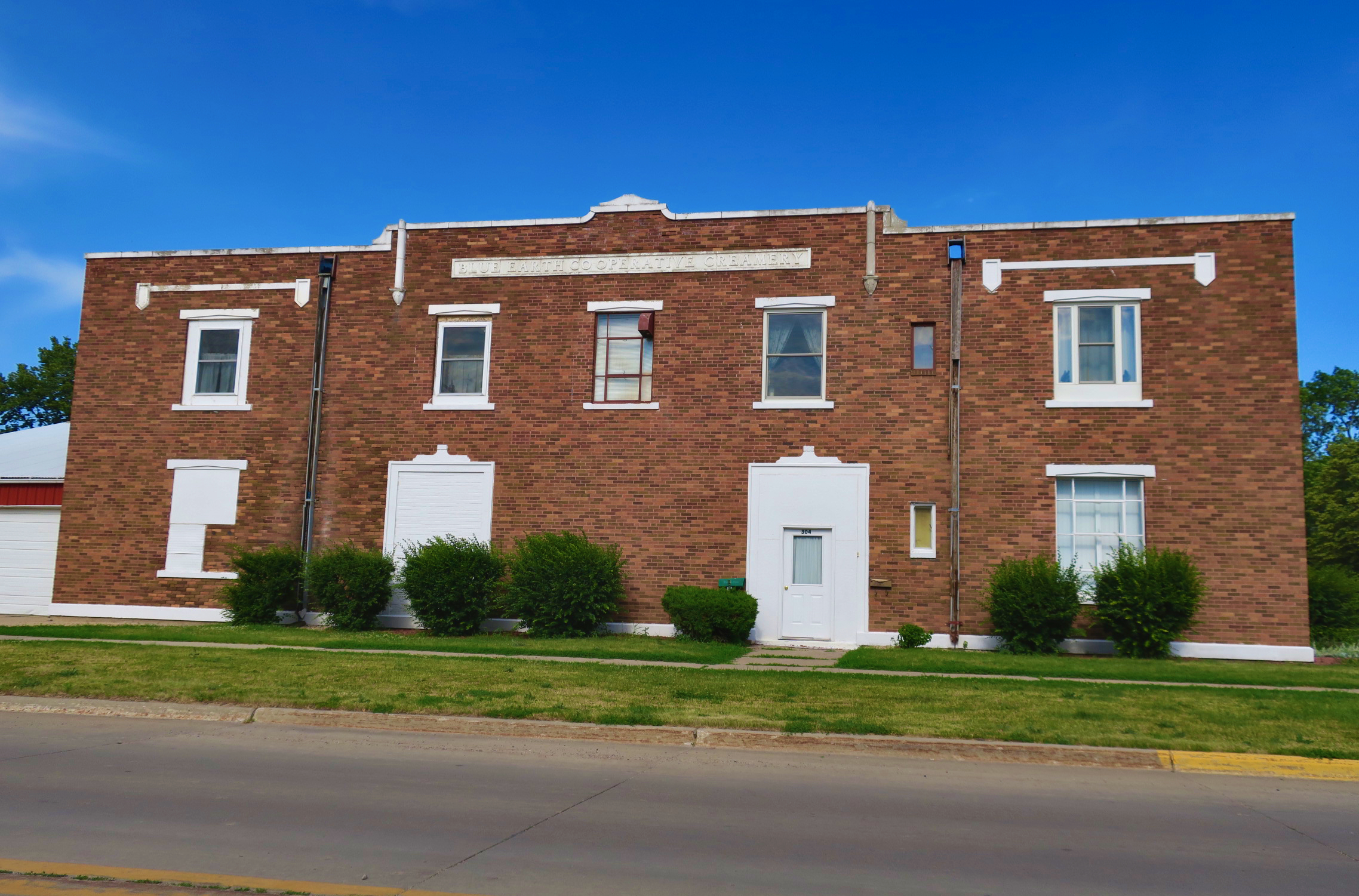 Blue Earth Co-Operative Creamery building, front view showing the original brick facade